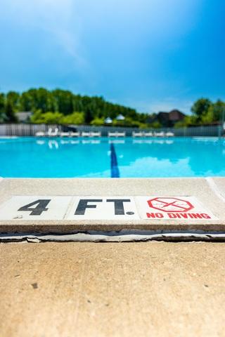 The concrete around this community pool had settled causing trip hazards around the entire edge of the pool.