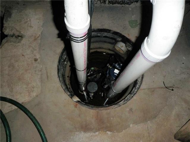 <p>The old sump pump has water stains surrounding it, a sure sign its not doing its job.</p>