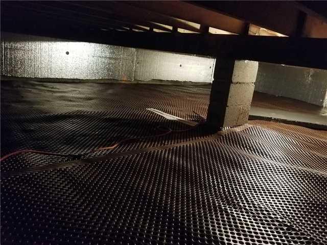 Our crew installed drainage matting to prevent standing water from getting trapped beneath the vapor barrier liner.