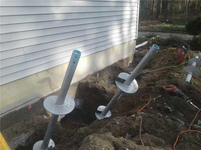 Our team removes the soil from the area where the piers will be installed. Each pier section  is screwed into the ground using special hydraulic equipment. Additional steel sections are then added to extend the pier to the appropriate depths and capacities, and a steel foundation bracket is connected to the Helical piers and attached to the foundations footing.