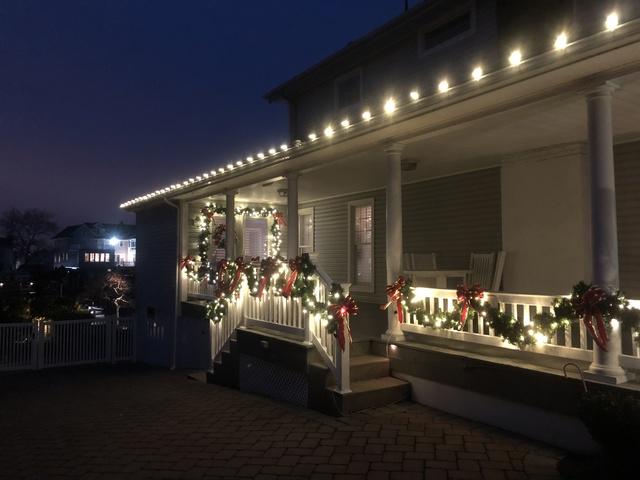 Why just decorate the front of your home? This homeowner added lit garland to the sides and back of his home, creating a display that can be enjoyed from any and every angle.