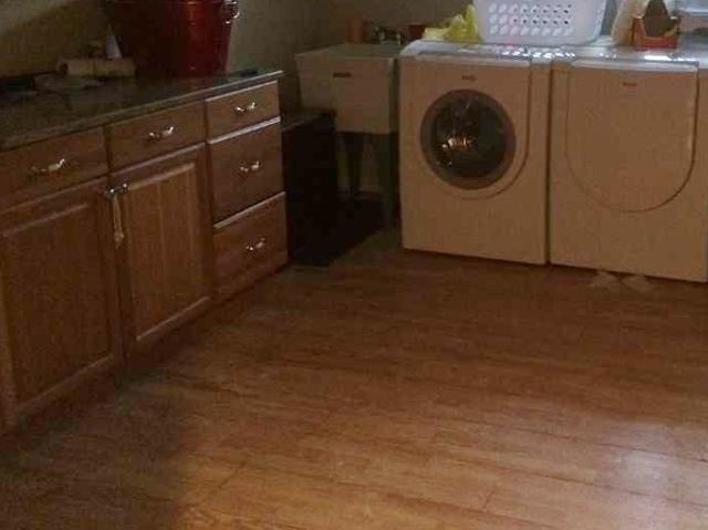 <p>The floor of this laundry room shows discoloration, a sign of water damage.</p>