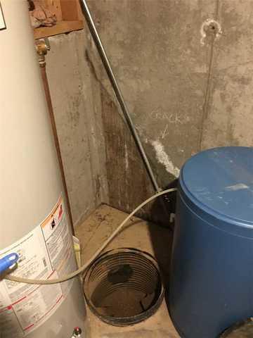 You can see that there is no sump pump and no water in the crock.  Since there was water on the floor, no water in the crock is a good indication that the draintile is not working.