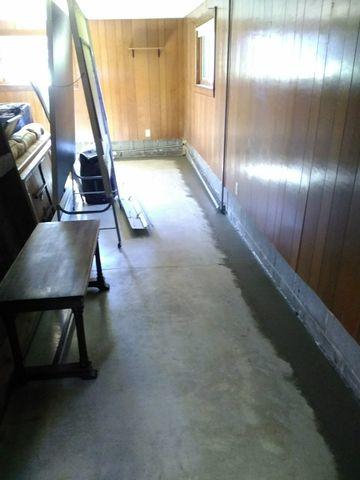 WaterGuard drainage system has been installed around the perimeter of the basement, and the concrete has been replaced.