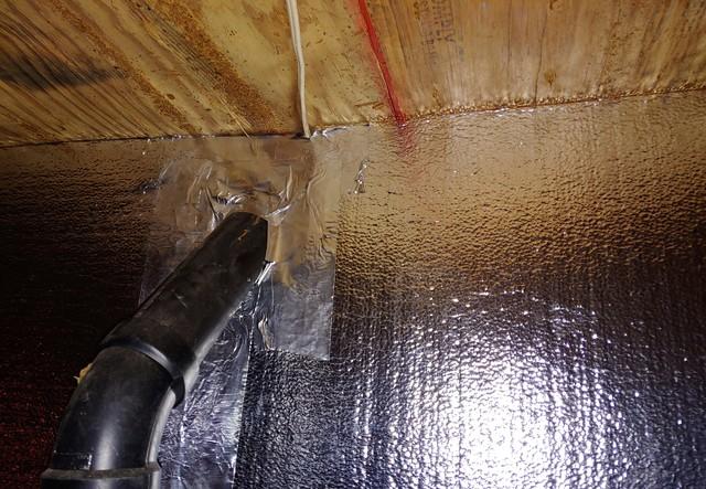 The SilverGlo panels are put right up against the joists of the floor. Here you can see another example of the maneuverability of the SilverGlo around the home's piping.