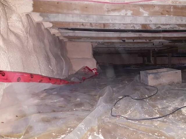 The homeowners installed plastic on the ground as a way to keep the humidity down, but it was flimsy and not properly sealed to the spray foam insulation.