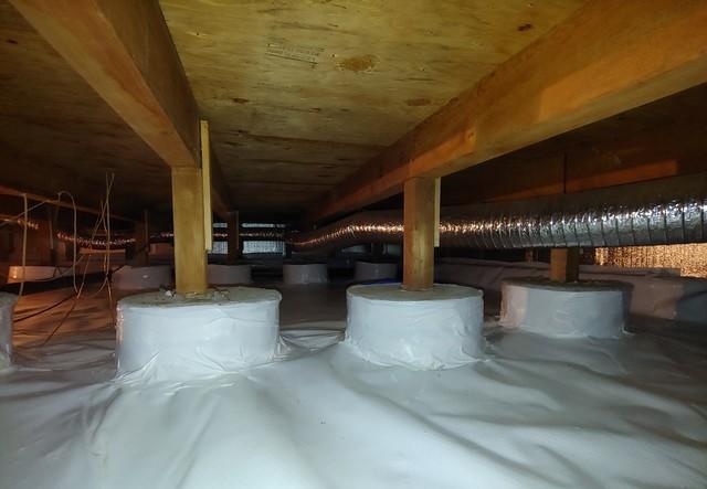 To further minimize the amount of water/vapor that can enter the crawlspace, the floor pillars are wrapped and sealed by the vapor barrier.