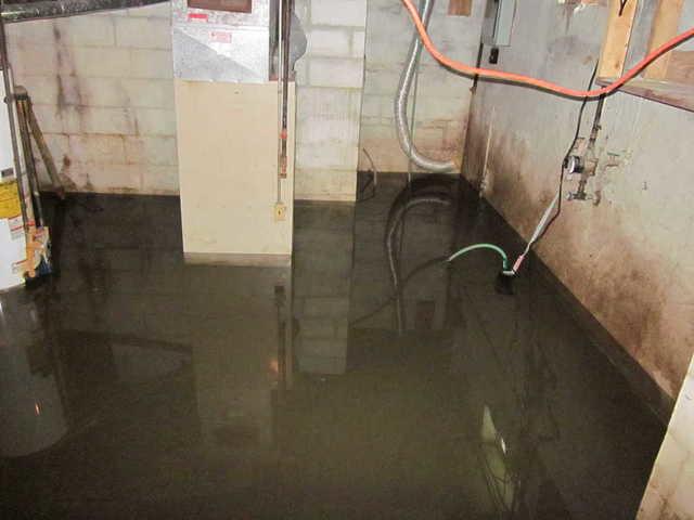 This Fenton, Missouri basement has experienced flooding, which creates several hazards, not the least of which is electrocution. As you can see in the picture, there are several wires which are immersed in the water. If one of those wires were to be damaged this basement could become a deathtrap.