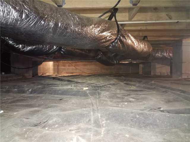 High humidity and moisture in this crawl space was causing havoc on the wood beams and joists