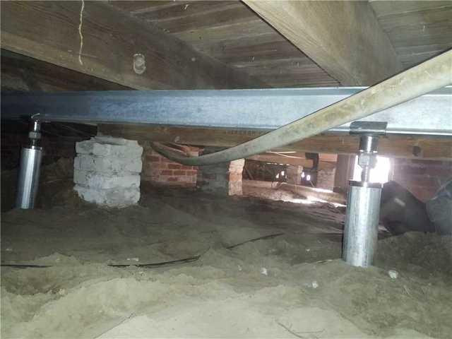 A SmartJack System was installed in the crawl space to support the home above. SmartJacks are capable of supporting loads over 60,000 pounds each.