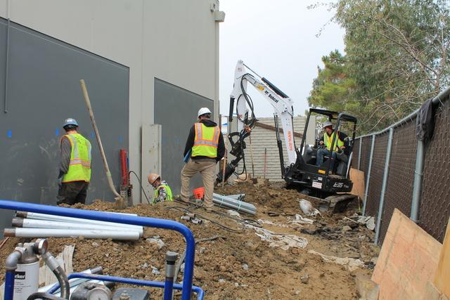 Installing piers to lift and stabilize building