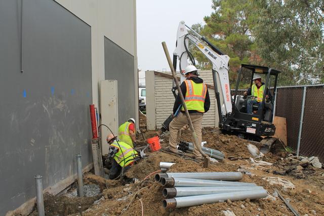 Installing piers to lift and stabilize building