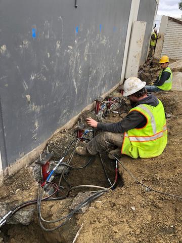 Installing piers to lift and stabilize building