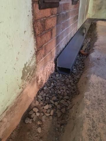 After breaking out the floor, we laid down clean stone and installed the WaterGuard on top of that.  All that is left once this is complete, is the concrete on top.