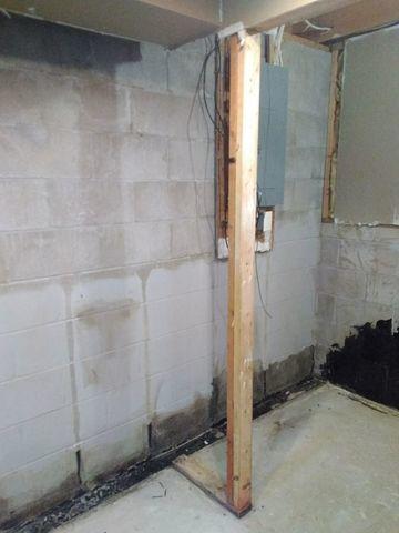 Water seeping into the basement through the block foundation, causing damage and compromised air quality.