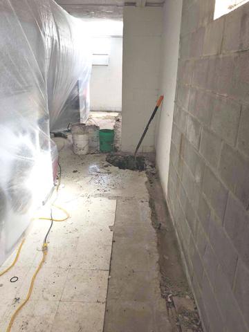 The crew has removed the concrete along the inside perimeter of the basement. They are ready to install the WaterGuard Drainage system and SuperSump. The SuperSump is capable of pumping 2,220 gallons of water per hour smoothly and quietly.