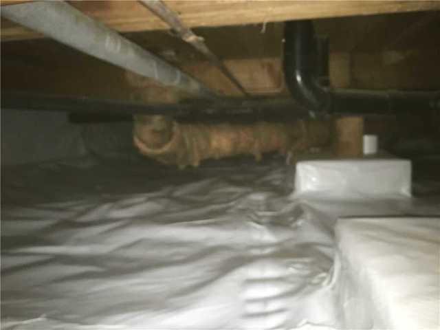 The clean space is wrapped around the bottom of the supporting joists to create an airtight seal.