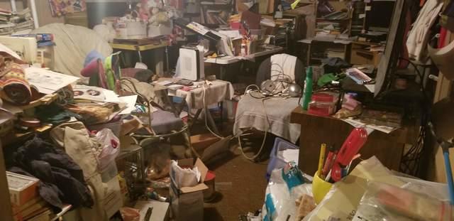 A room filled with stuff and 6 inches of mud and water covering all the corner items