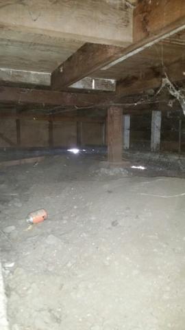 This home has wooden supports in the crawlspace.