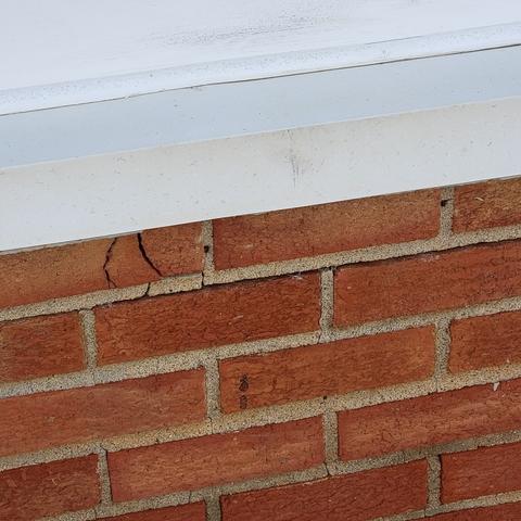 Visible cracks in the mortar and bricks