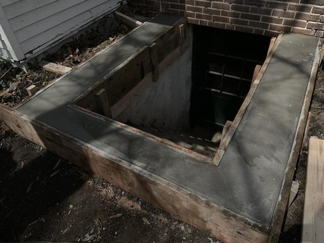 Complete repairs around the foundation for cellar door installation.