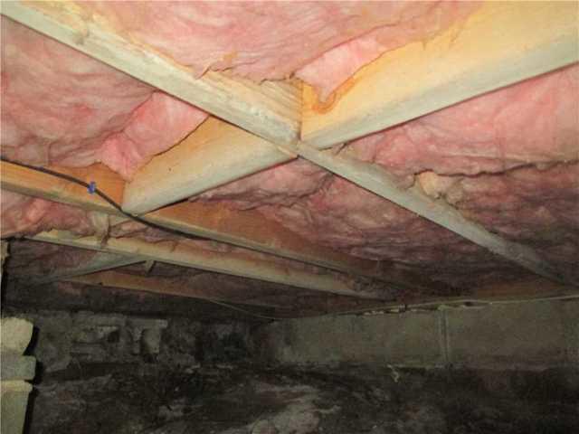 A view of the dirty crawlspace before CleanSpace was installed