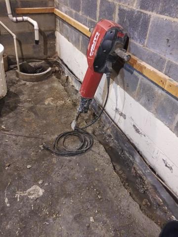 <p>This image shows one of the several tools used in basement waterproofing, the jackhammer. This power tool is used to loosen the existing cement floor in order to install the waterproofing system. In the photo you can see the moat like trim along the perimeter of the room where the drainage system will later lay.&nbsp;</p>