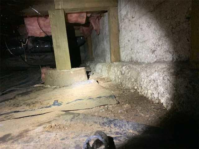 Water has been seeping in through this foundation wall and covering the crawlspace floor.