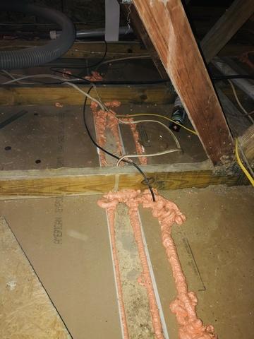 <p>This photo shows where we sealed all of the potential points of air leakage in and out of the attic. The orange puffy stuff is what is actually doing the sealing, and this step is necessary before insulating the floor. The insulation will not fully do it's job if the floor is not first sealed.&nbsp;</p>