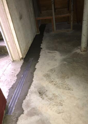 A Trench Drain was installed by the basement water to stop the water that comes down the outside steps from entering the basement.