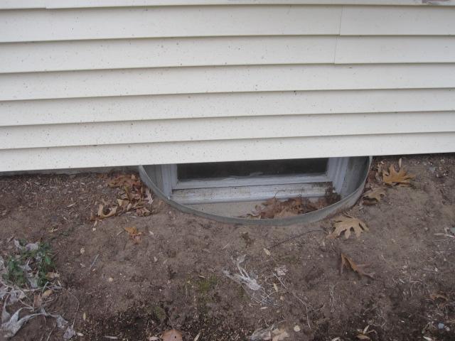 This window well in Ivoryton, CT is rusty and old. Its dirt bottom allows dirty water to splash up onto the window, creating an ugly view. Our light-colored SunHouse window well features a sturdy, clear cover that fits nicely and a bottom that prevents weed growth as well as keeps leaves, debris, and rain out. With the clean, light-colored bottom, a lot more sunlight bounces into the basement and brightens up the space.