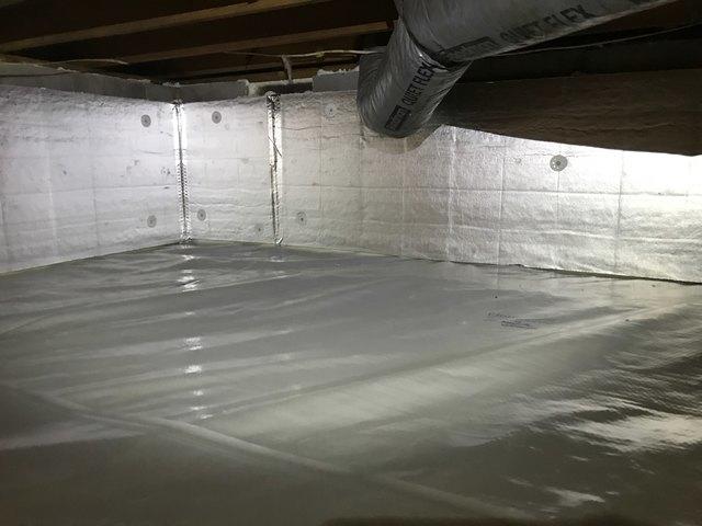 FoamBoard insulation is fastened to the wall to create a continuous layer of insulation on the foundation walls.