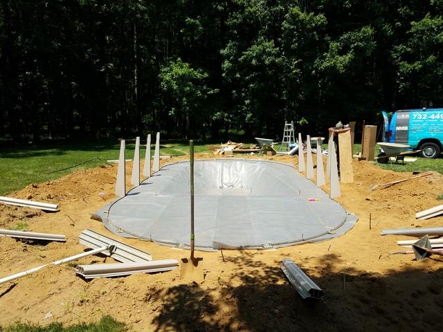 A protective barrier is laid down on the sand to protect from rocks, plant life, and animals from damaging the pool in the coming years.