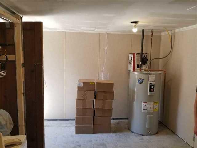 Unfinished laundry room with concrete floors.