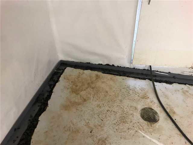 WaterGuard was installed around the perimeter of the basement to collect any water seepage from the walls and the ground. The drain was covered with cement for a clean finish.