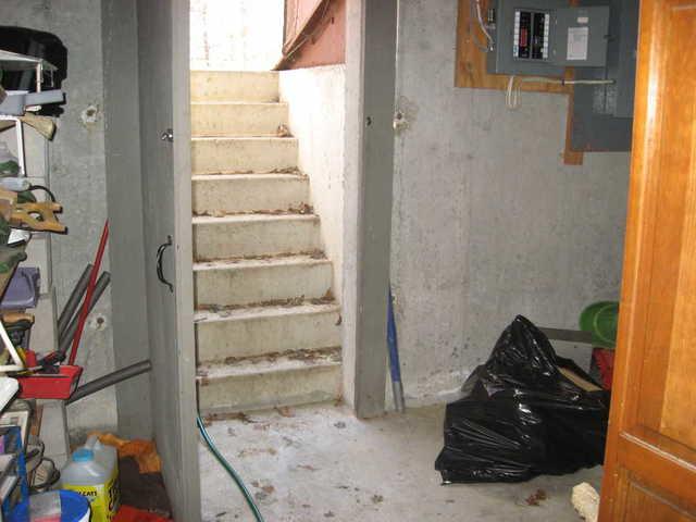 <p>The basement of this Gales Ferry, CT home had a staircase leading into the basement from the outside. Water often can come in through these stairs, as was happening in this home. To prevent water from entering the basement, we installed a trench drain at the base of the staircase. Its open grate collects water into the perimeter drainage system to keep the basement dry.</p>