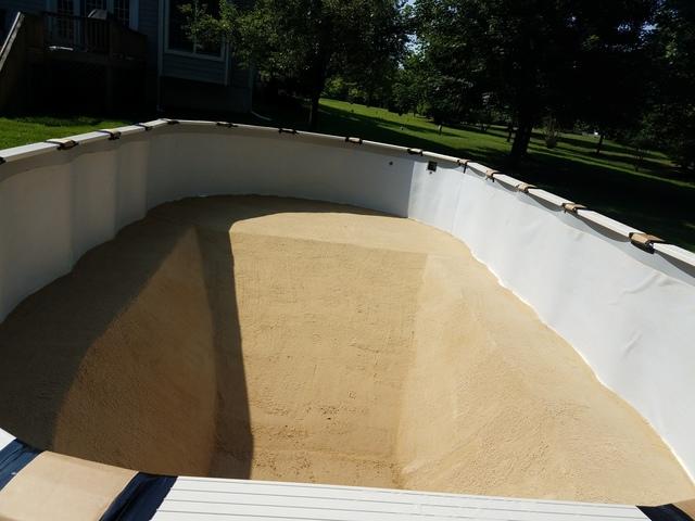 Once the sand is laid, the crew hand levels the pool floor and deep-end!