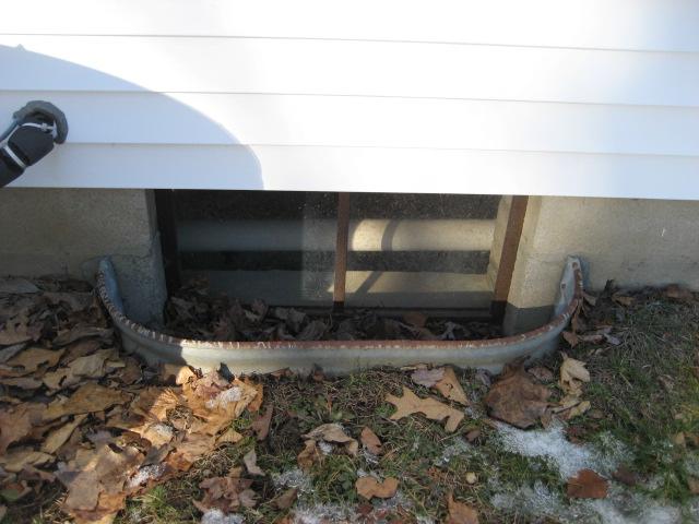 Old window wells like this are rusty, dirty, and can collect debris like leaves and sticks. All this makes for a dark and grimy view from the basement. Our SunHouse window well features a sturdy, clear cover that fits nicely and a bottom that prevents weed growth as well as keeps leaves, debris, and rain out. The light-colored curved bottom of the SunHouse window enclosure, enhances the sunlight entering the basement.