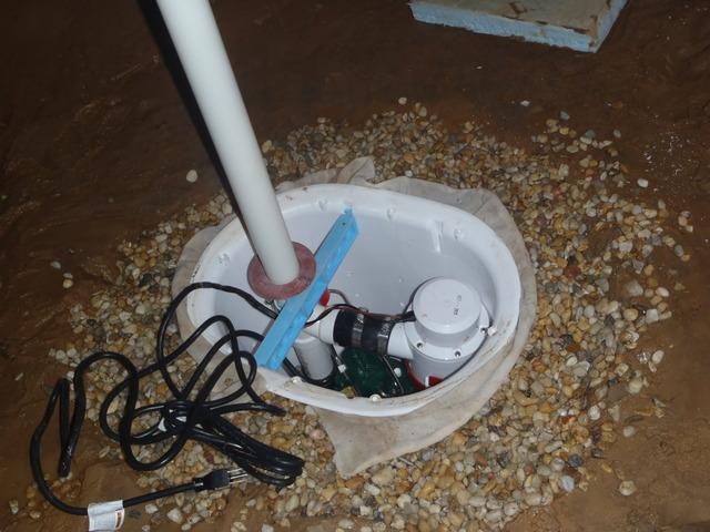 <p>The Dr. Energy Saver Delmarva production crew has dug out a hole in the lowest spot of the dirt floor of this crawl space and have placed the SmartSump sump pump inside. The SmartSump sump pump system is specifically designed for crawl spaces. It has features like an automatic float switch and an airtight lid.&nbsp;</p>