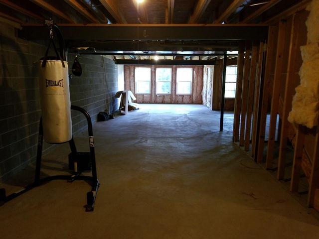 Some workout equipment was the only thing inhabiting this unfinished space.