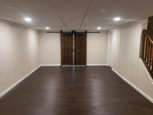 Look at those barn doors!!! 

Our customer chose to customize her space with these gorgeous barn doors that go perfectly with the espresso-colored ThermalDry flooring, which looks like wood but is actually made from inorganic materials and will never swell, mold or rot should water ever enter the space.