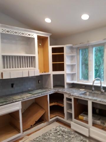 Halfway through painting these cabinets white!