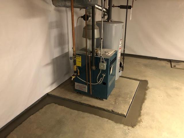 You can see our CleanSpace Wall System on the walls and the perimeter of the basement was waterproofed using our WaterGuard Sub-Floor Drainage System in this Holden, MA basement.