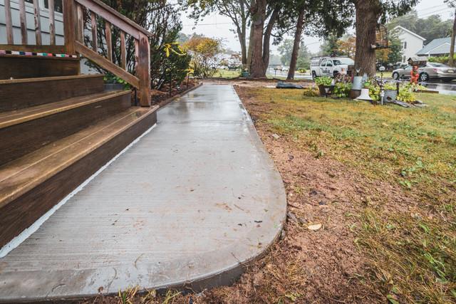 Finished Concrete Front Sidewalk by Quality 1st Basements