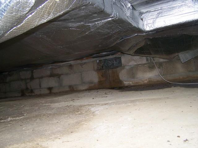 The water seeping in through the crawlspace walls had nowhere to go once it came inside the basement, allowing it to collect. Our team installed crawlspace drainage matting. This dimpled plastic mat material is creates a drainage space that helps water find its way to the drain lines, preventing possible mold and rot in the home. 