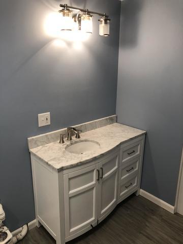<p>basement bathrom with paintable panels and gray plank</p>
