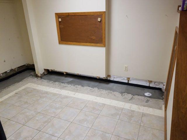 This basement had water damage to the walls and flooring.