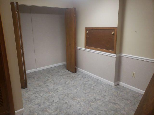 Another shot showing the wall restoration, new flooring and baseboards.