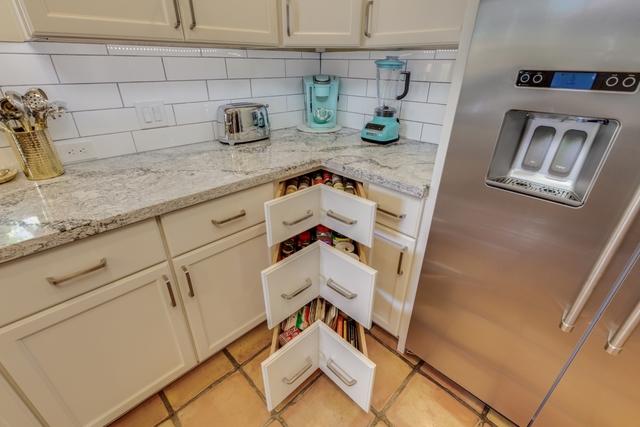 Great storage for spices and baking supplies! Starmark Cabinetry, Dove color, Stratford door style, Maple species, Soft close doors and drawers. Cambria Seagrove Quartz countertops.
