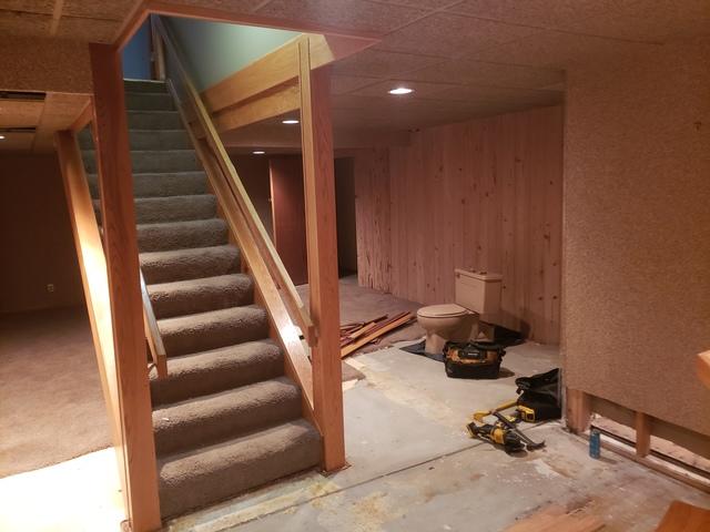 Before, carpeted stairs, floor being worked on